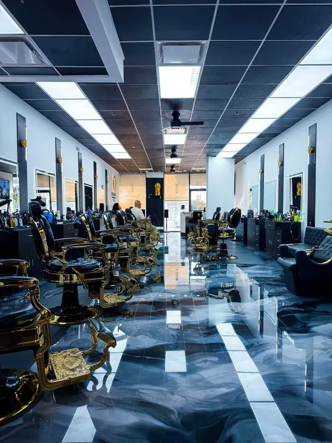 Gold barber chairs on the marbled floor