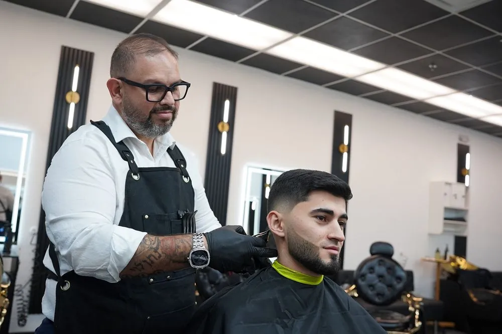 Eduardo Gamero detailing a client's fade at Legacy Barbershop